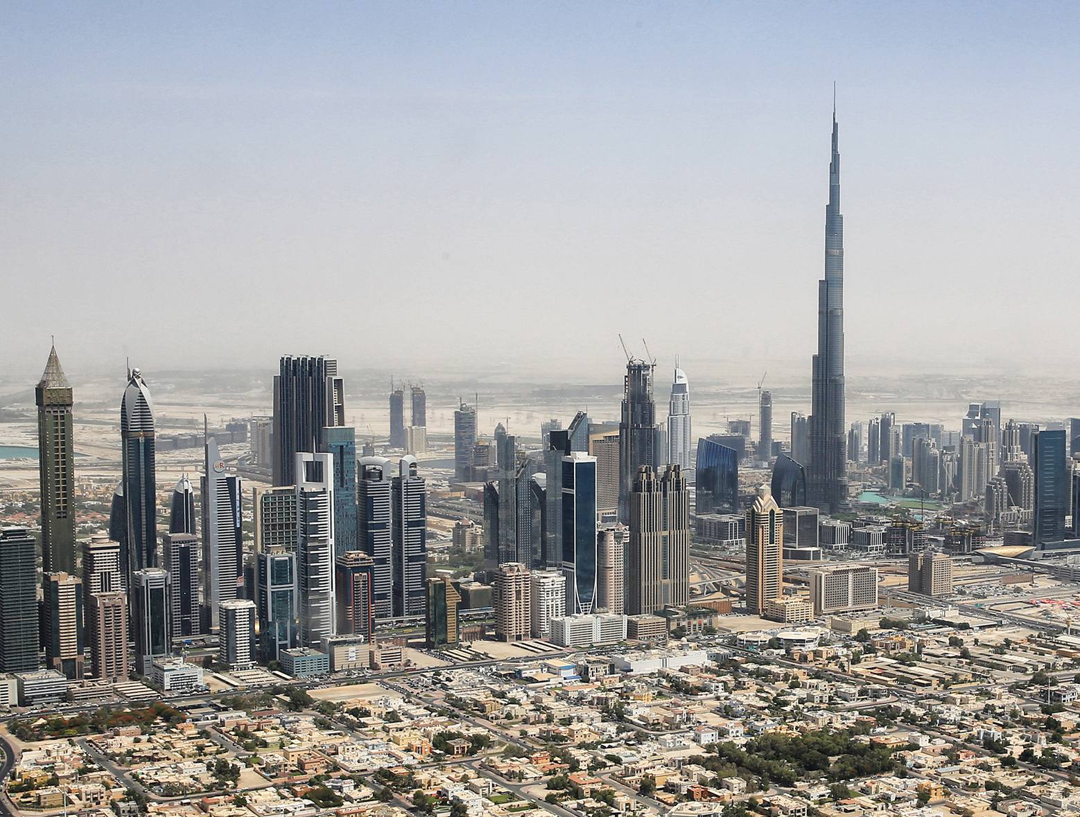 Dubai from the air: the towers along Sheikh Zayed Road and the Burj Khalifa rising above the city
